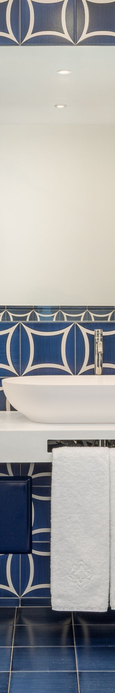 Blue tiled bathroom with double vanity and mirror