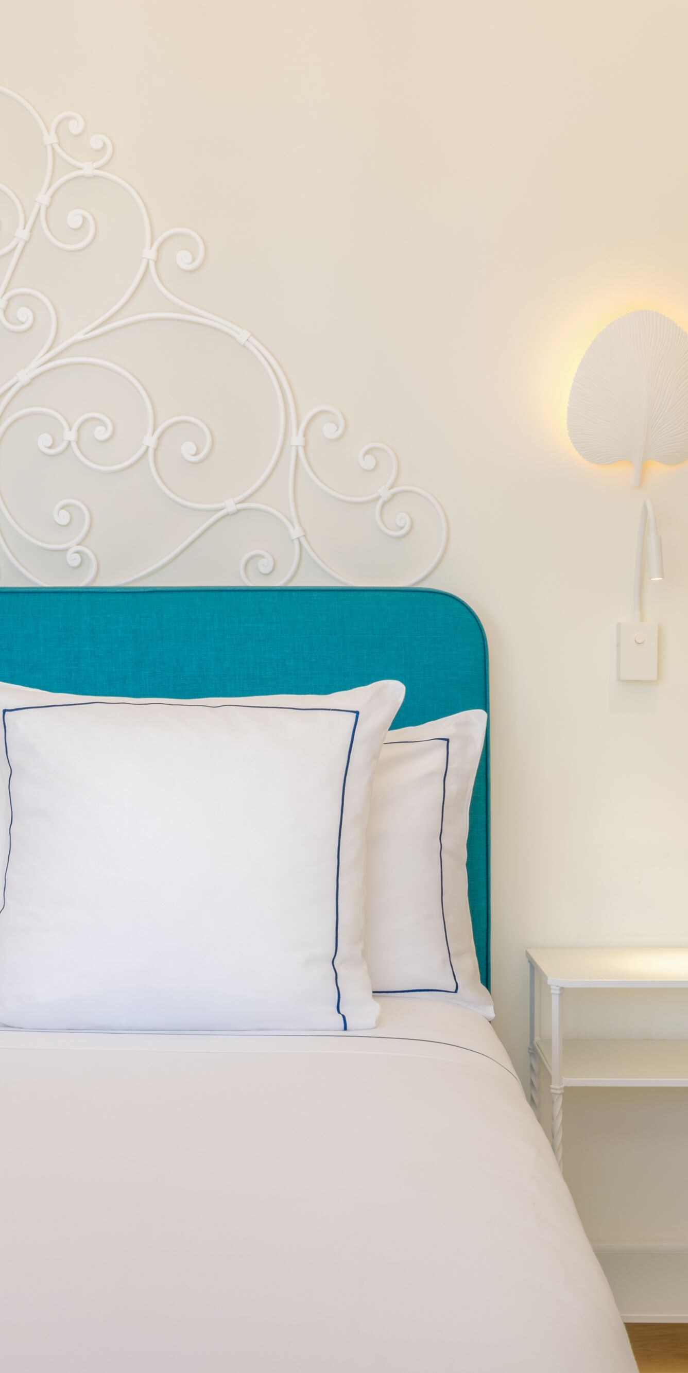 guest room with decorative headboard and desk