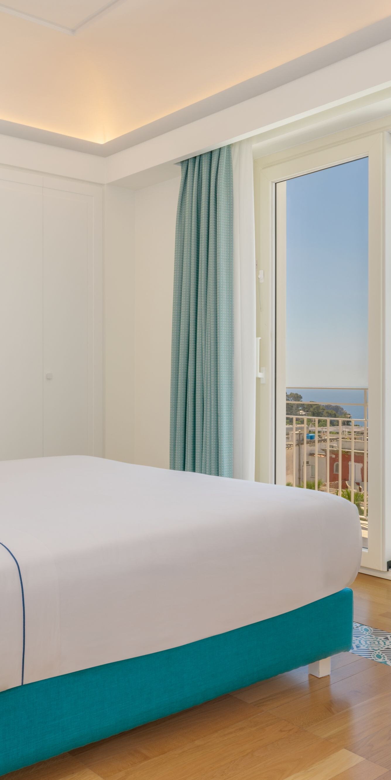 Guest room with balcony view and lounge chair