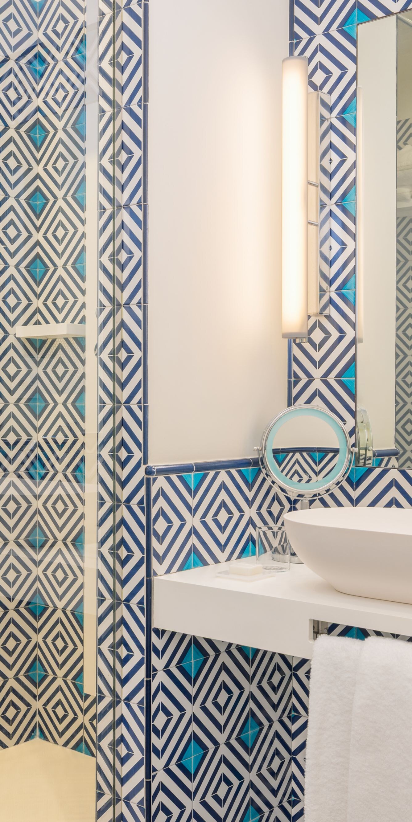 patterned bathroom with vanity and glass shower