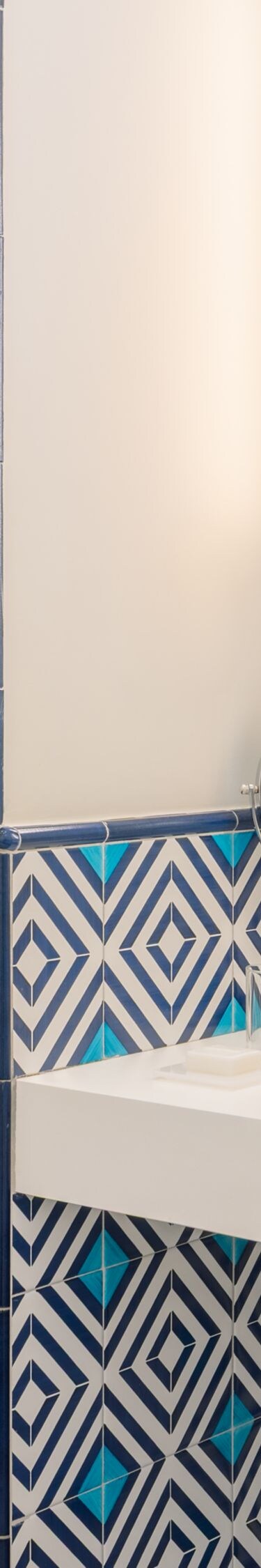 patterned bathroom with vanity and glass shower