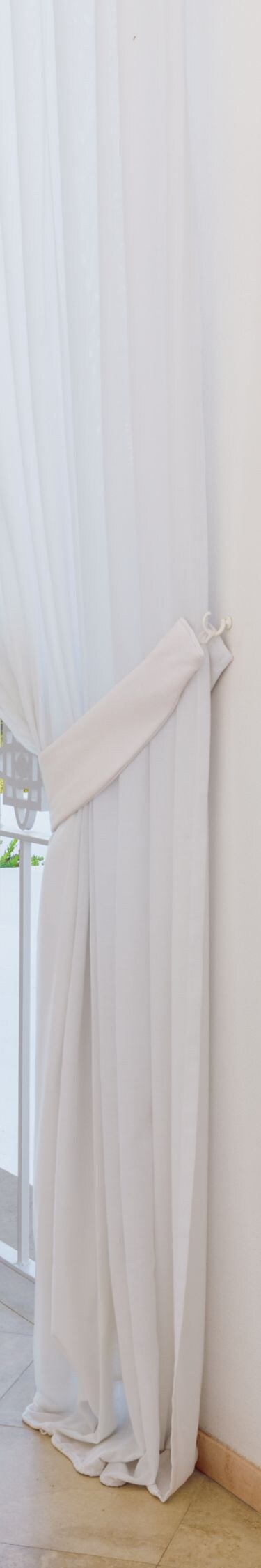 Covered balcony with seating and garden views