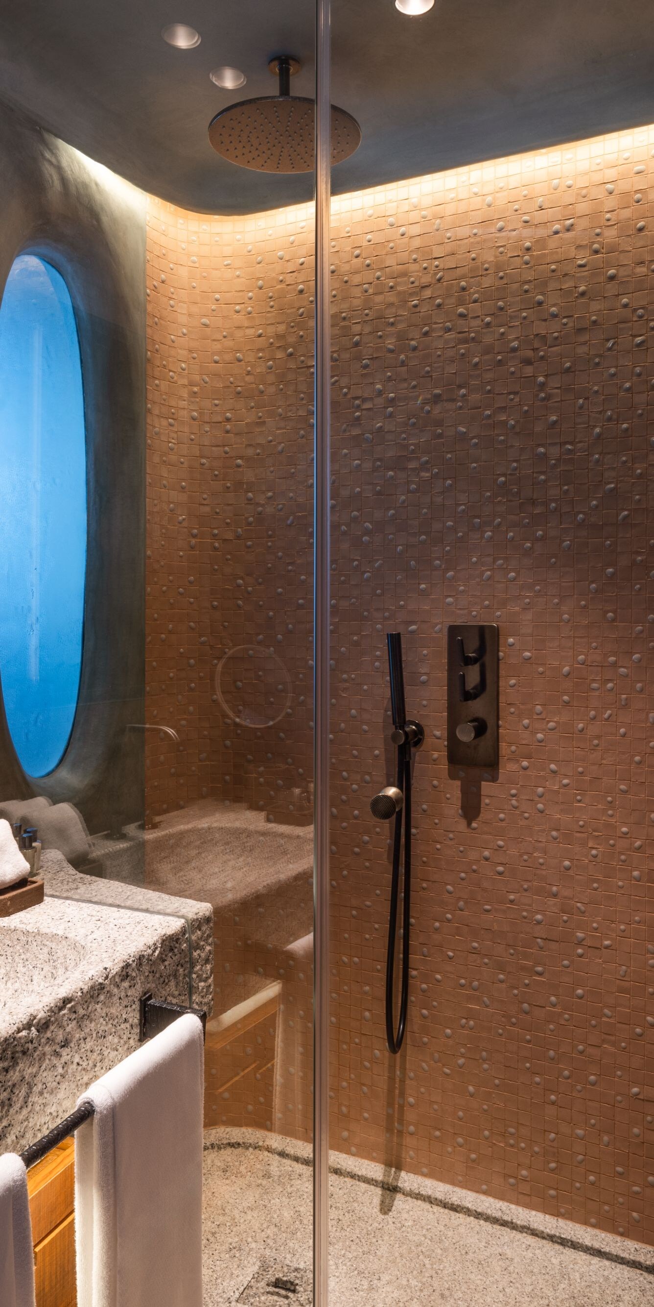 Walk-in shower with stone vanity and robe