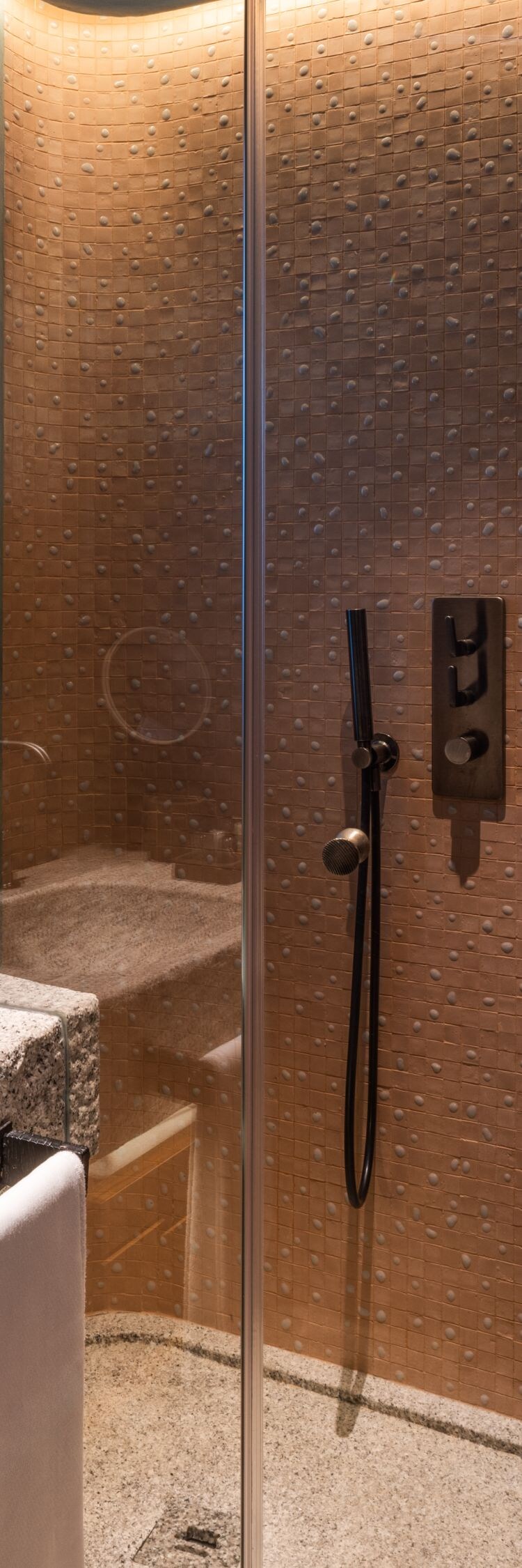 Walk-in shower with stone vanity and robe