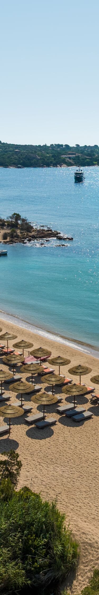 Aerial view of sandy beach and turquoise bay water