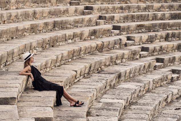 Woman sitting on the stairs of Kourion amphitheatr