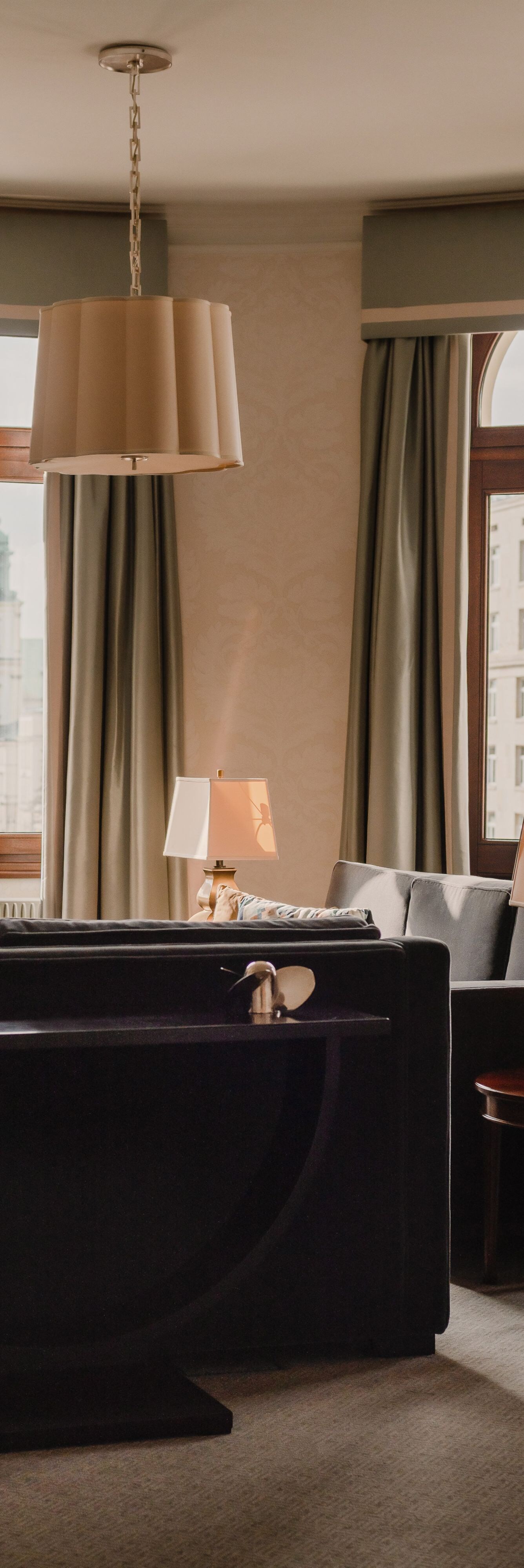 two sofas, lamps, small table, windows    