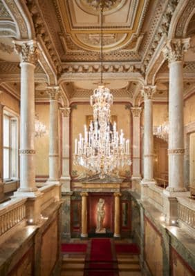 Elegant crystal chandelier in marble columned room