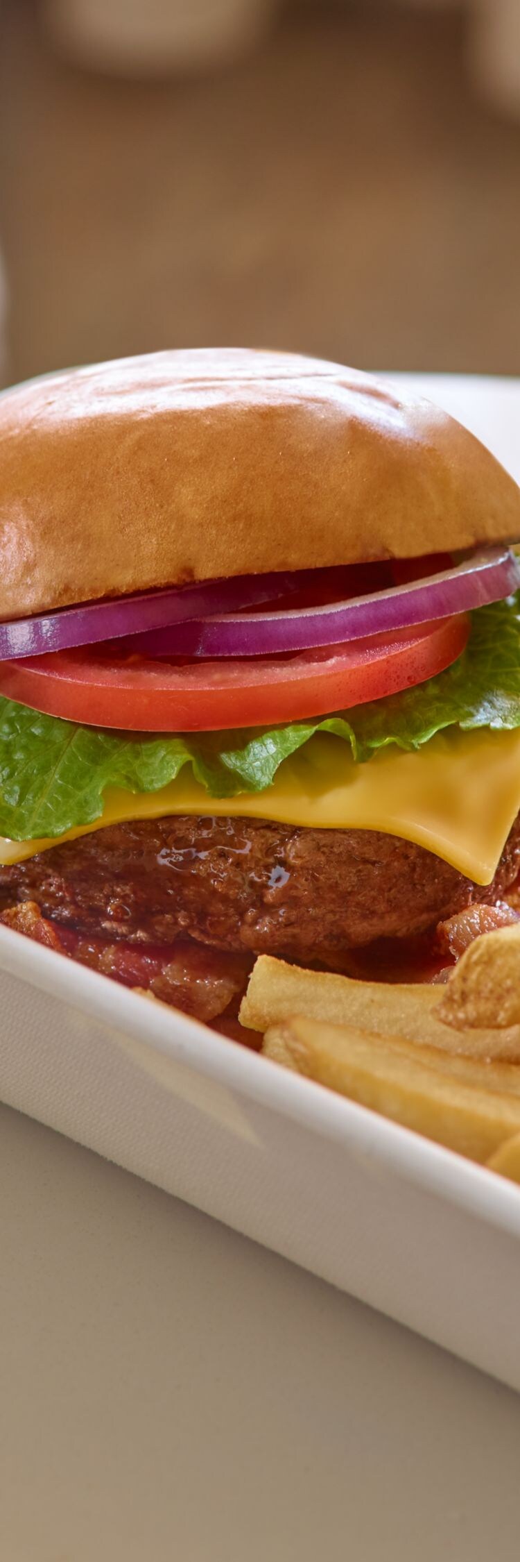 Cheeseburger, fries, cold beer, to go container