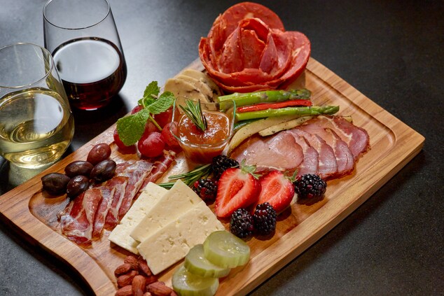 Charcuterie board of meat, cheese, fruit and nuts