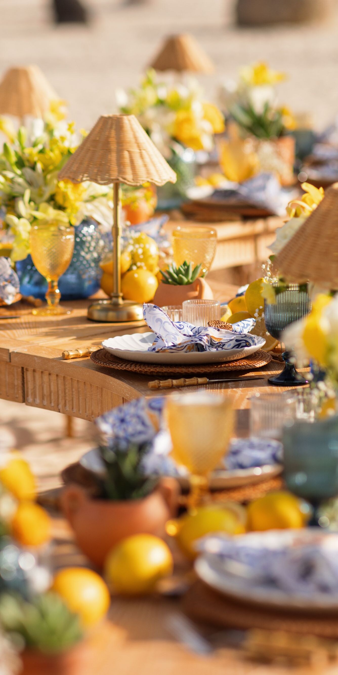 Long wooden reception tables arranged on a beach