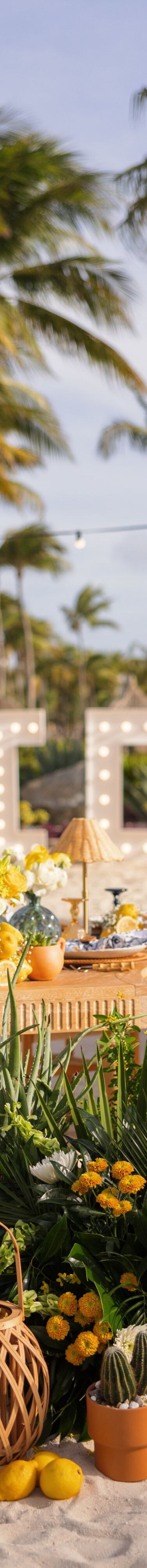Beachfront wedding reception setup on white sand 