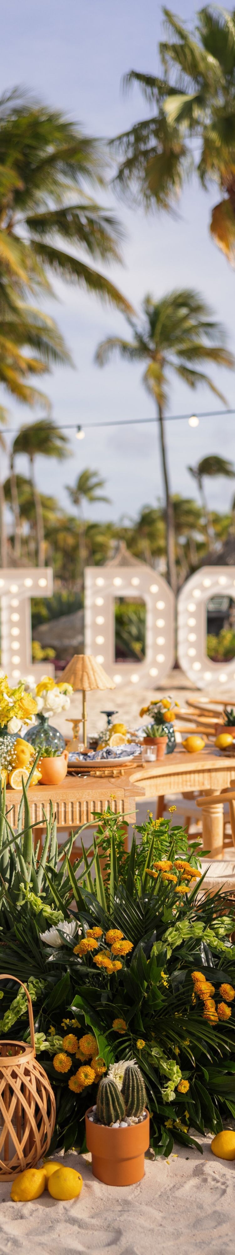 Beachfront wedding reception setup on white sand 