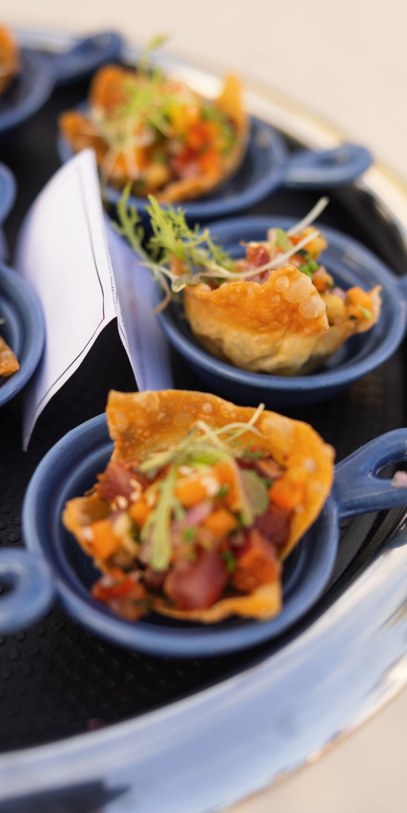 Assorted appetizer bites served on small blue dish