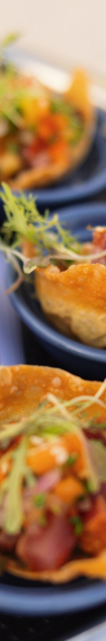 Assorted appetizer bites served on small blue dish