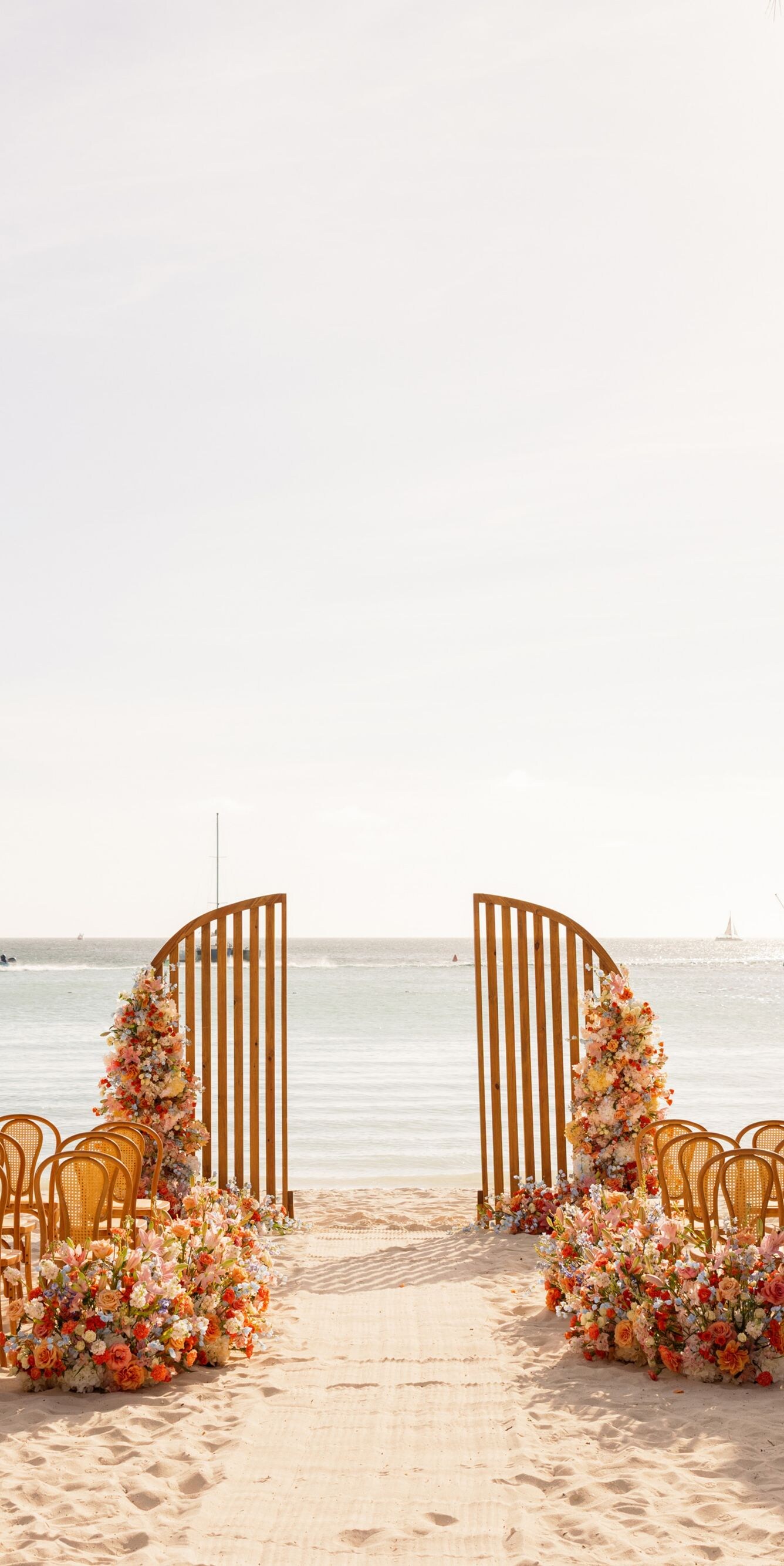 Beachfront wedding ceremony setup on a sandy beach