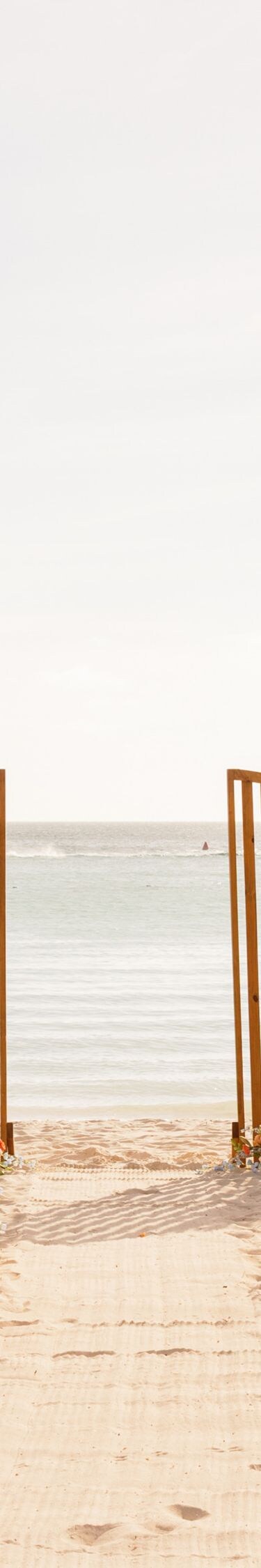 Beachfront wedding ceremony setup on a sandy beach