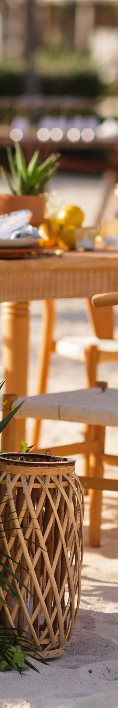 Beachfront wedding reception setup on white sand