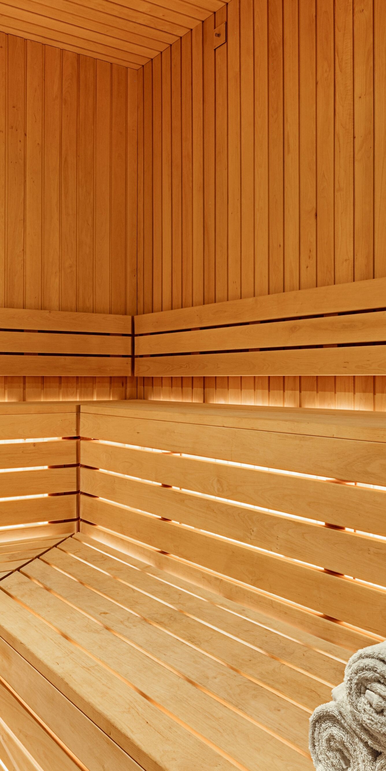 Sauna with wood paneling and towels