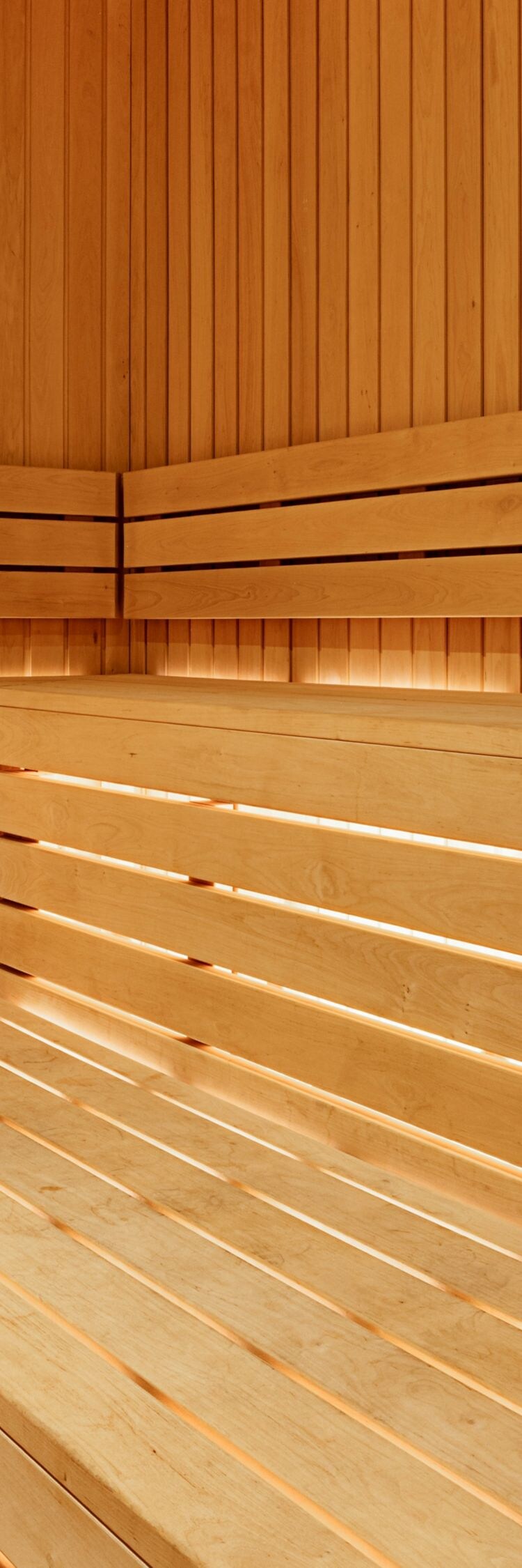 Sauna with wood paneling and towels