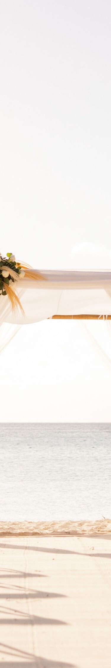 Beach wedding ceremony setup on a sandy beach