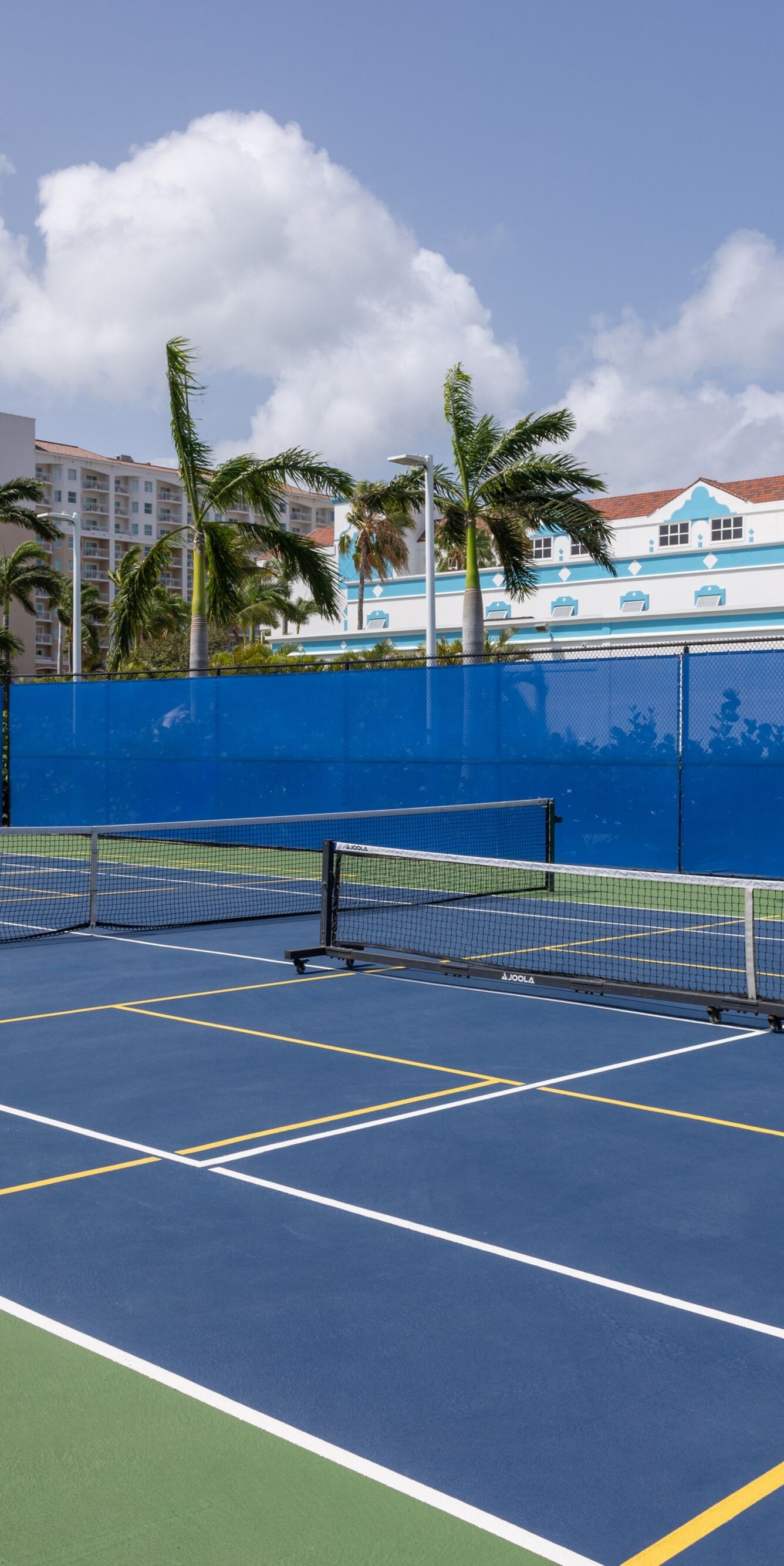 Outdoor pickleball court with a blue playing surfa