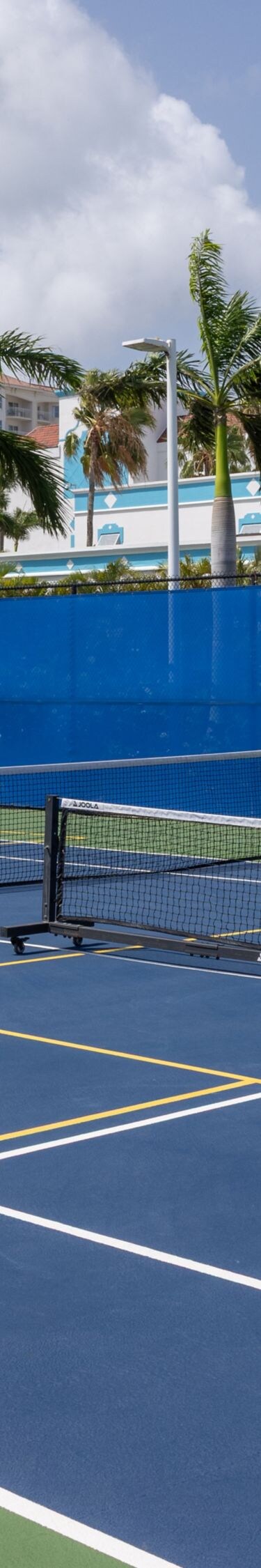 Outdoor pickleball court with a blue playing surfa