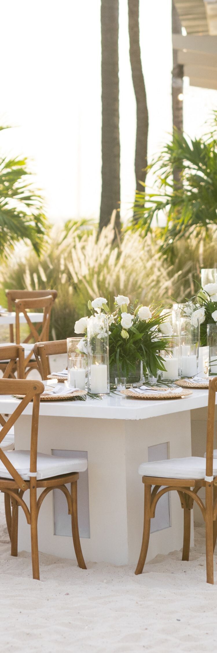 Outdoor wedding reception setup on a sandy beach