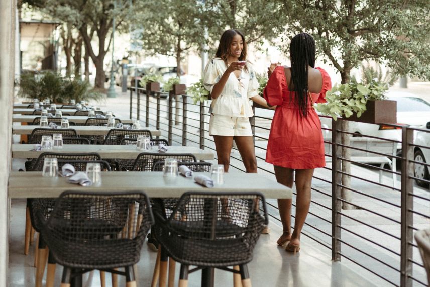 2 girls chatting on the Corinne Patio