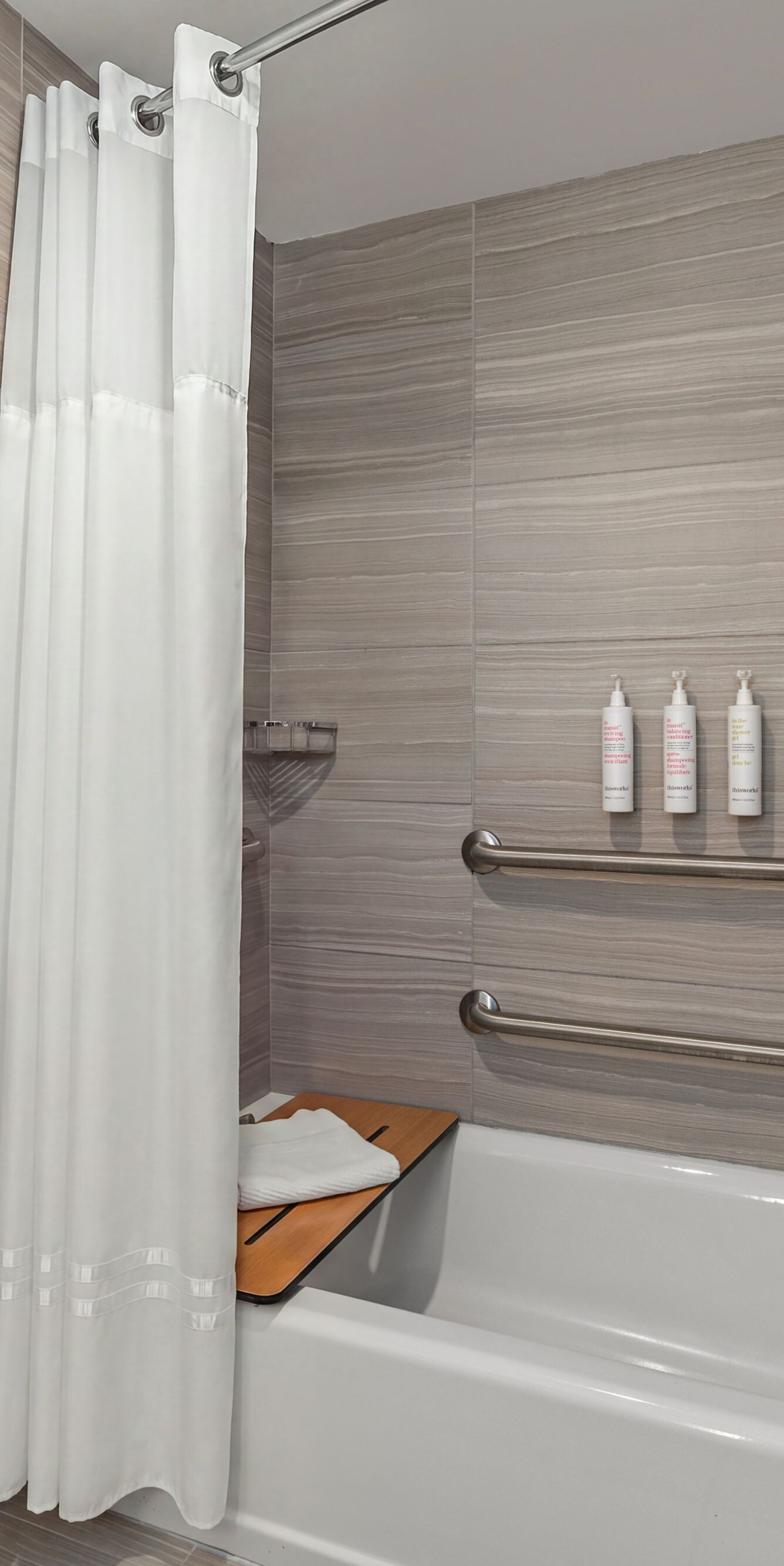 bathtub with grab bars and seat