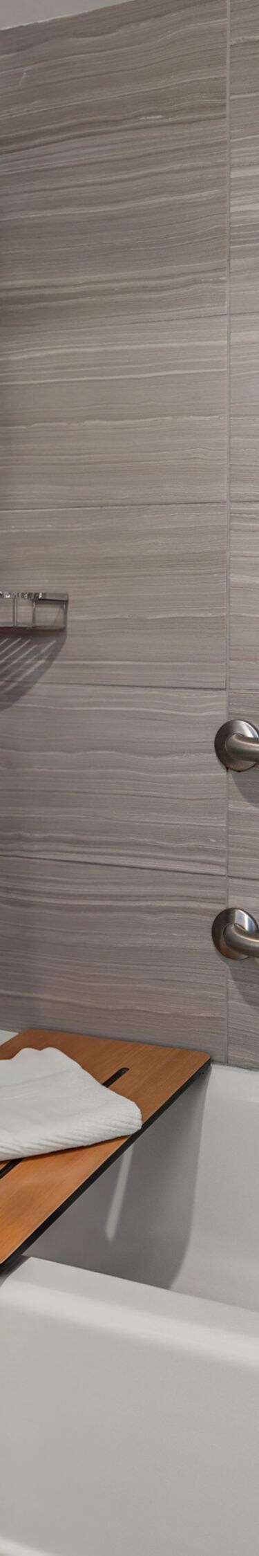 bathtub with grab bars and seat