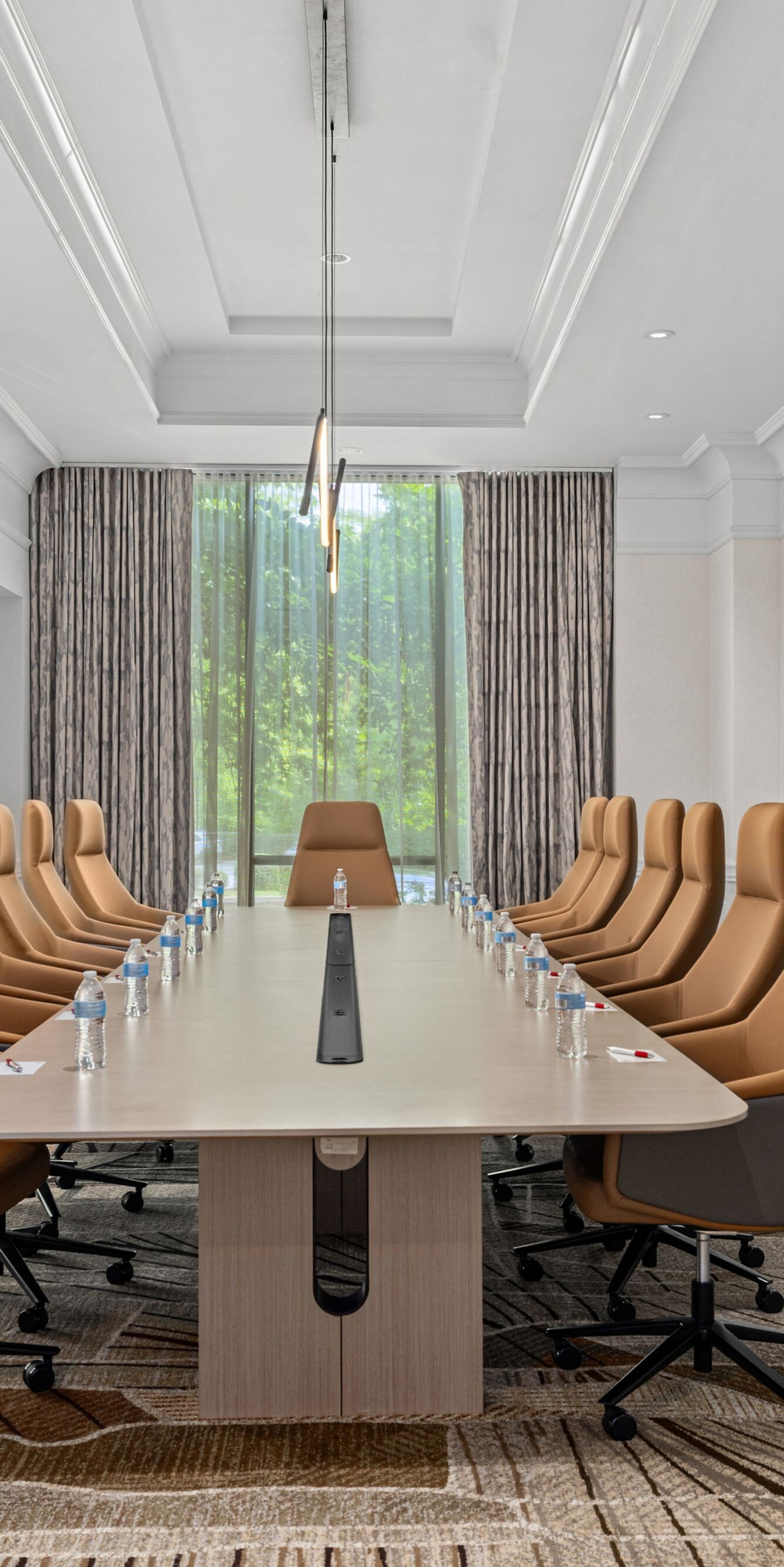 boardroom table with chairs on both sides
