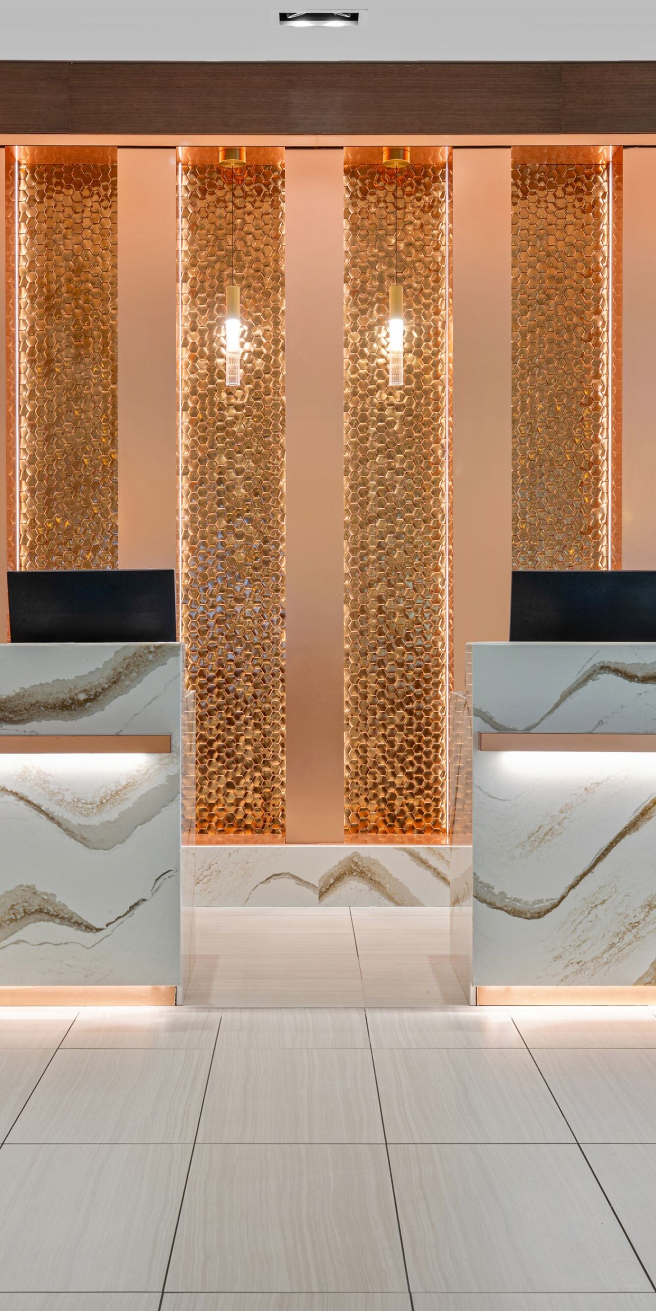 Lobby front desk area with accent gold wall
