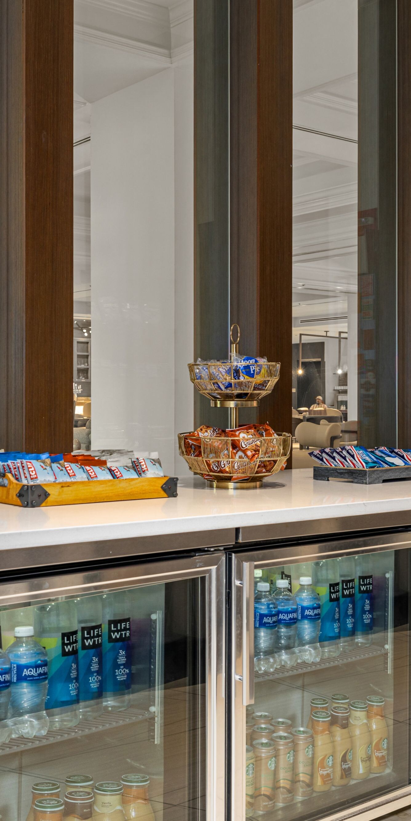 low coolers filled with drinks/counter with snacks