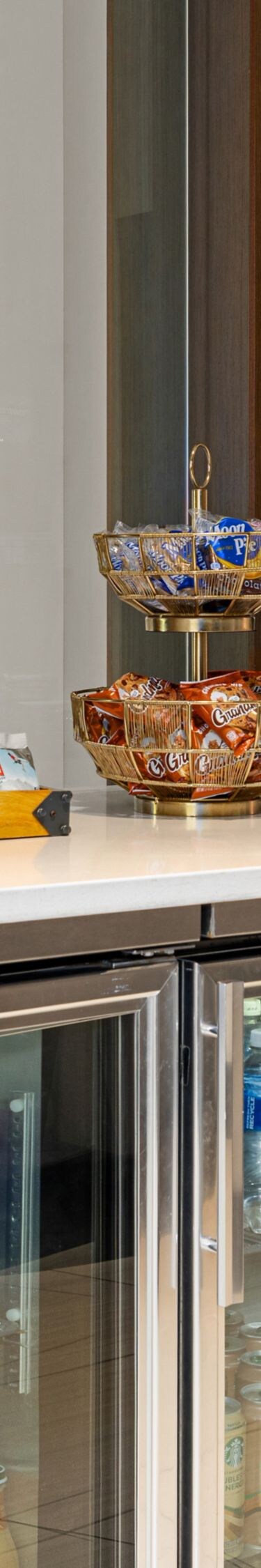 low coolers filled with drinks/counter with snacks