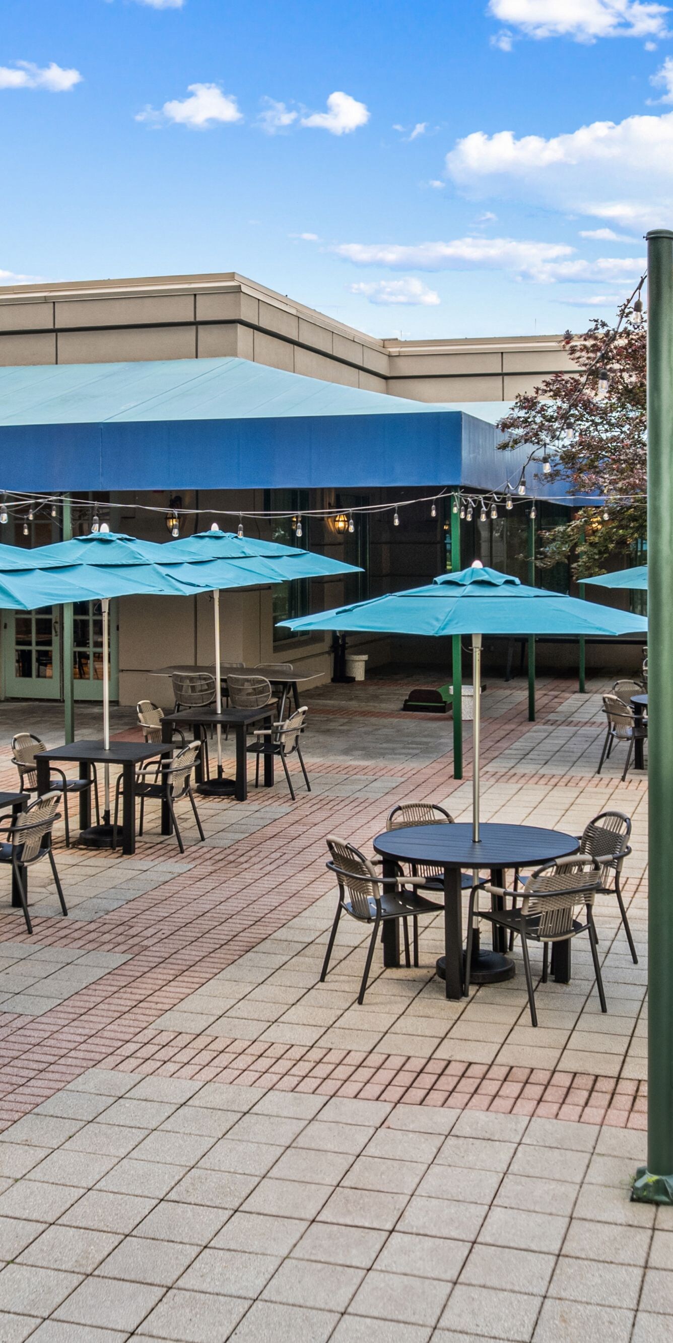 tables with umbrellas and chairs on patio
