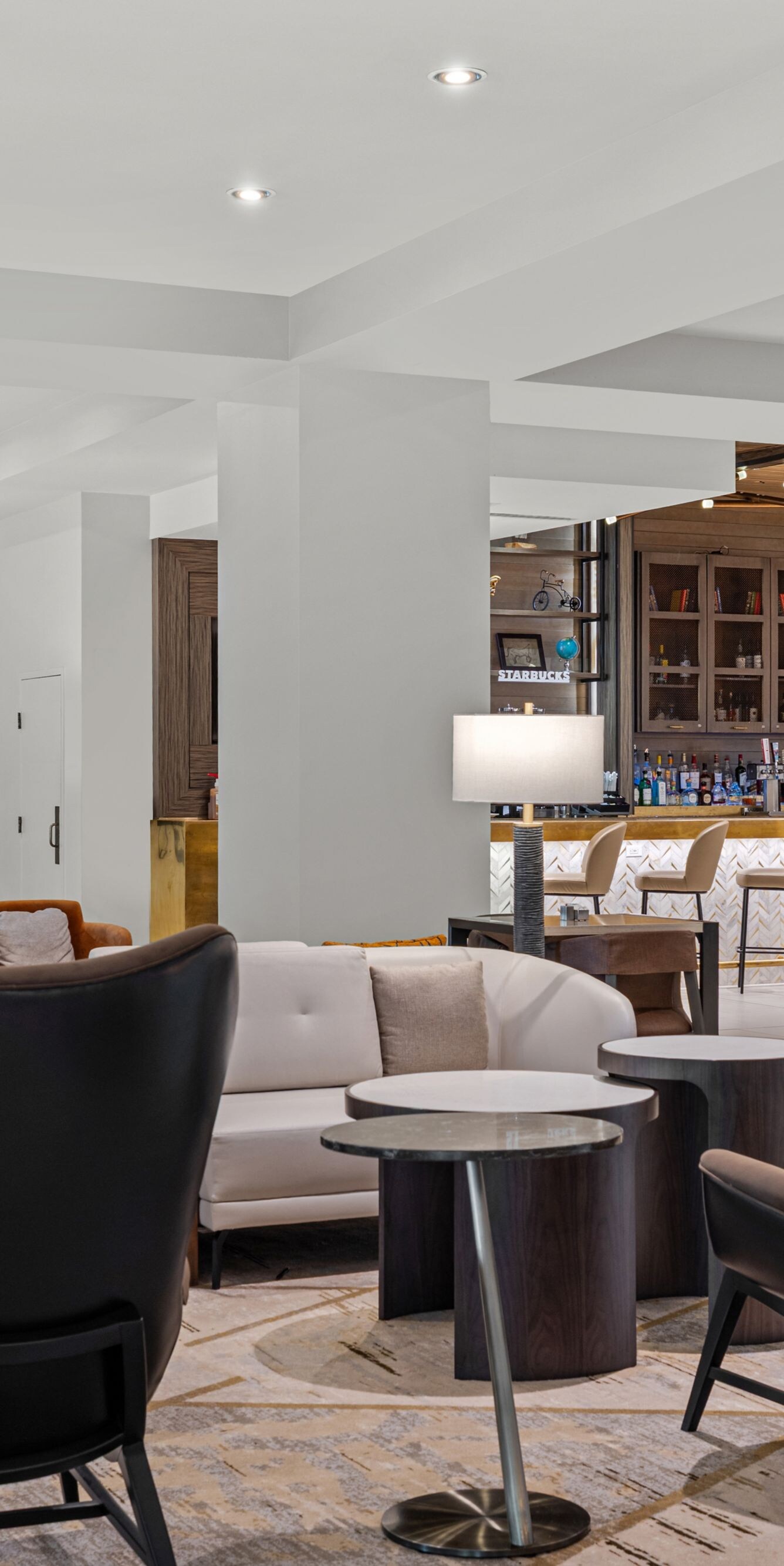 couches and chairs with a bar in the background