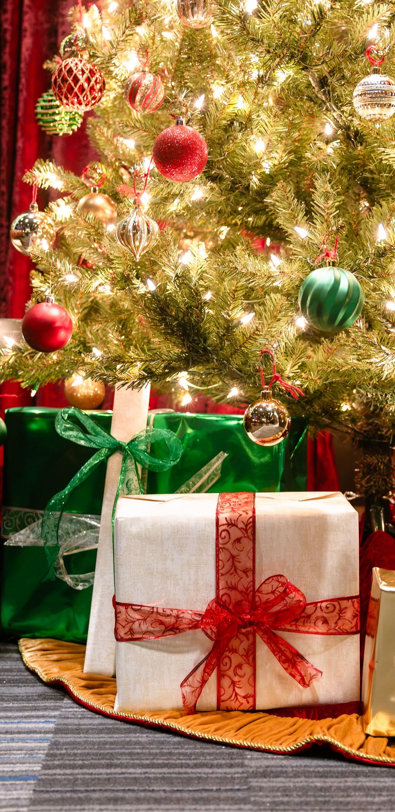 Wrapped gifts beneath holiday tree