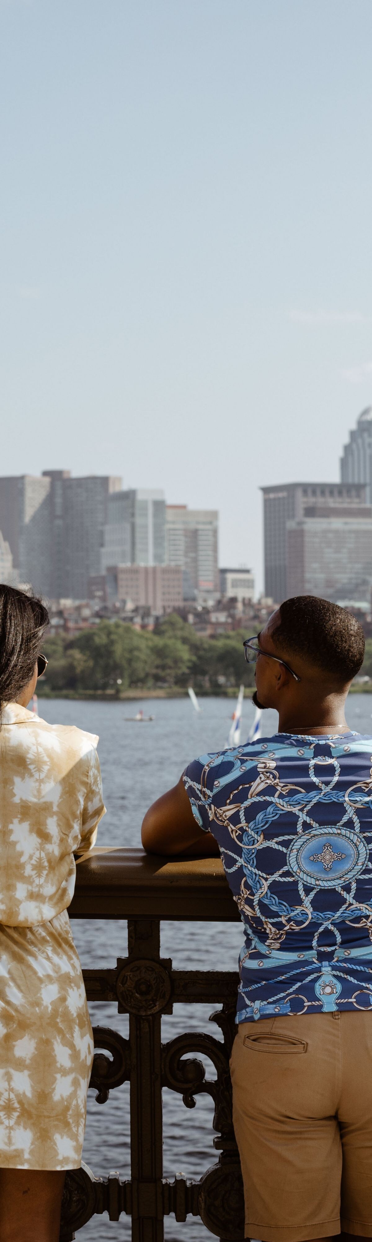 four people looking at river