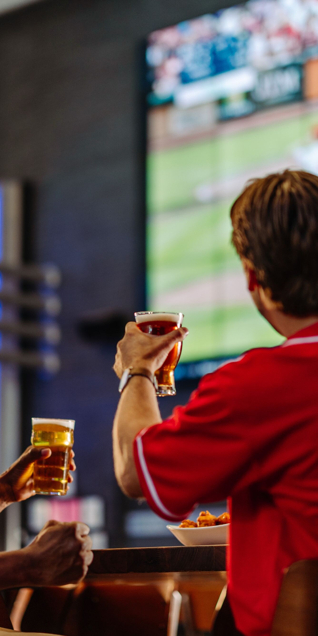 Guests watching a game at hotel bar