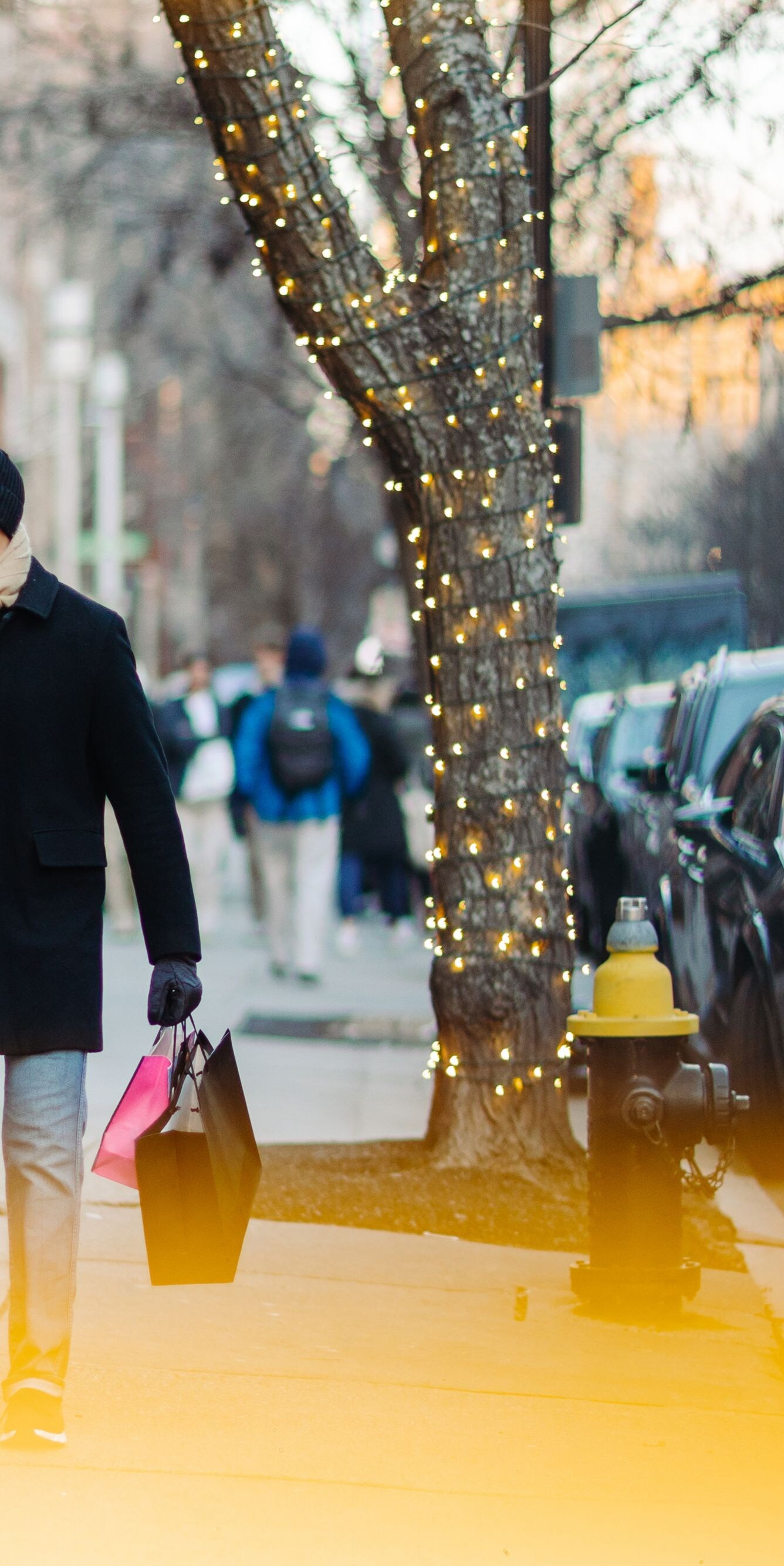 couple holding shopping bags on sidewalk