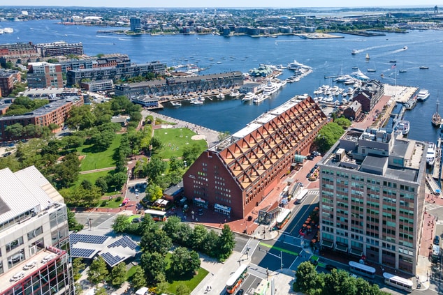 Aerial view of hotel, park, and Boston Harbor.