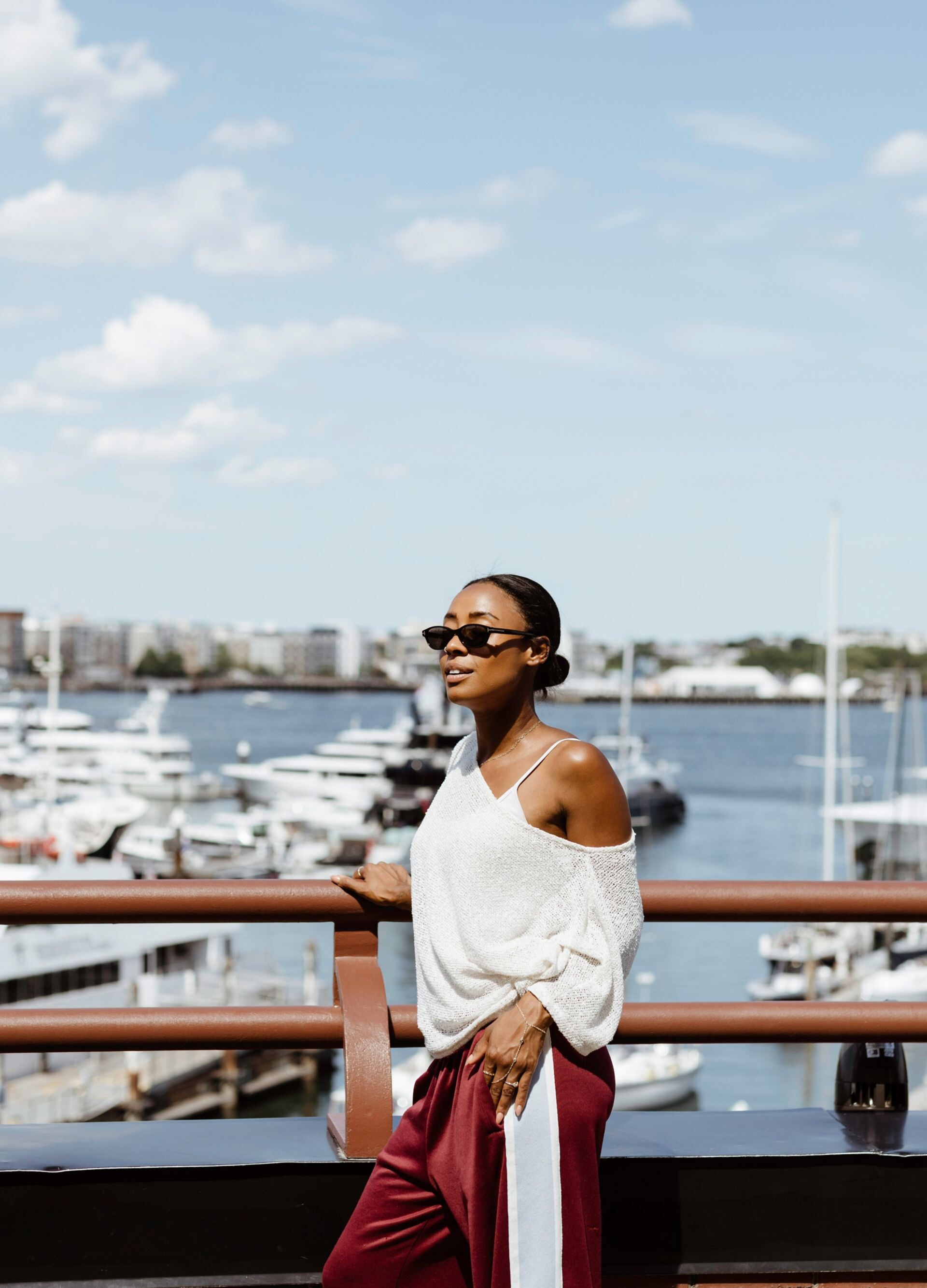 Woman on terrace with marina and yachts