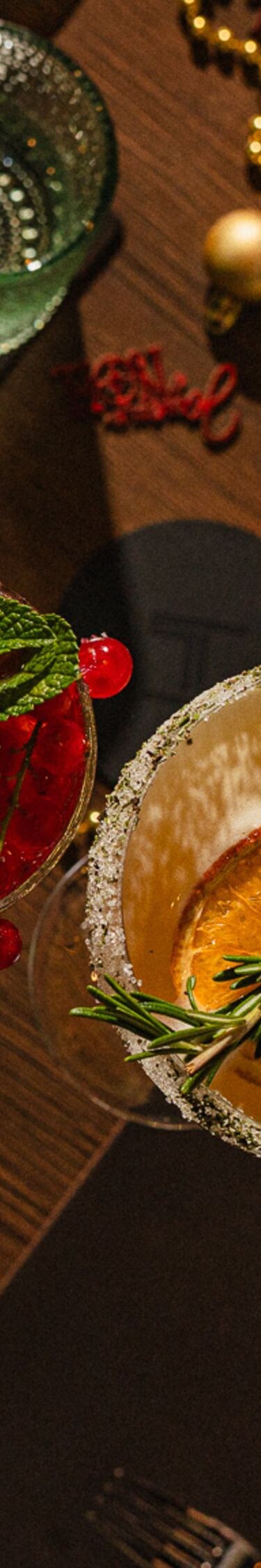 Cocktail glasses raised over a dinner table