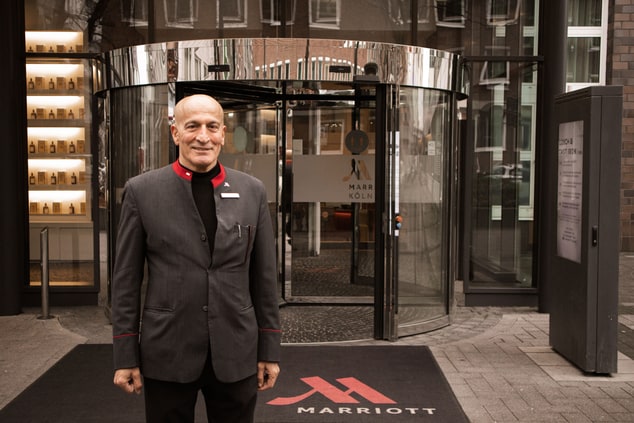 Concierge Mehmet in front of the hotel entrance.