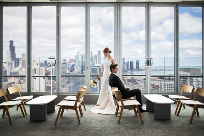 image of bride and groom in front of windows