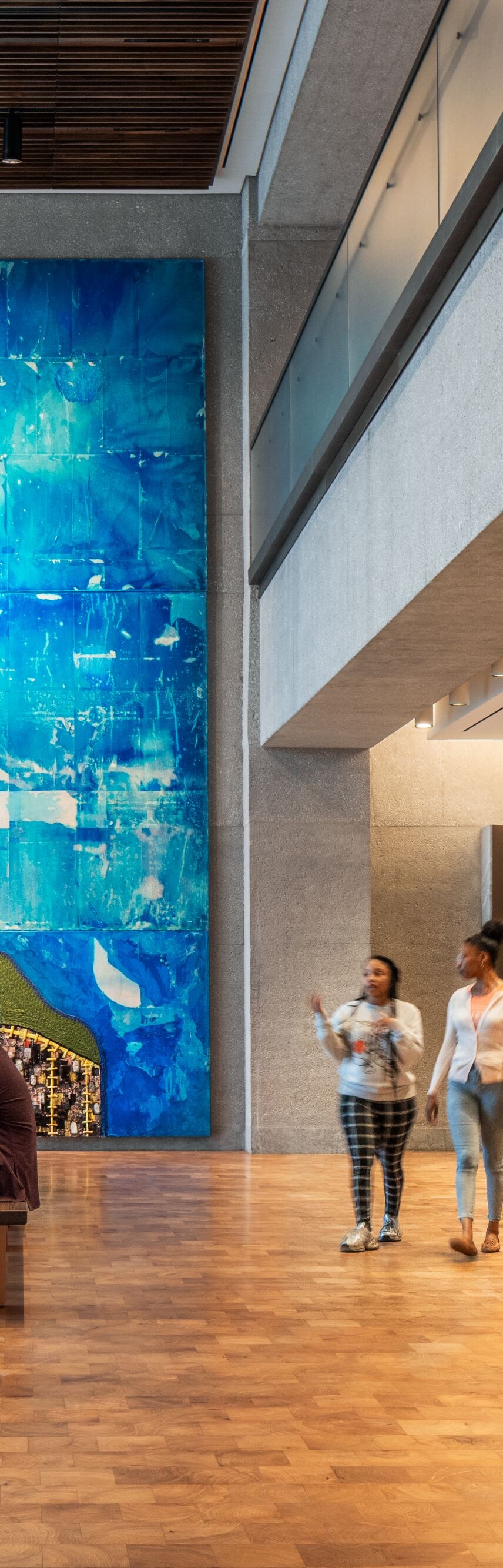Lobby with large mural and visitors