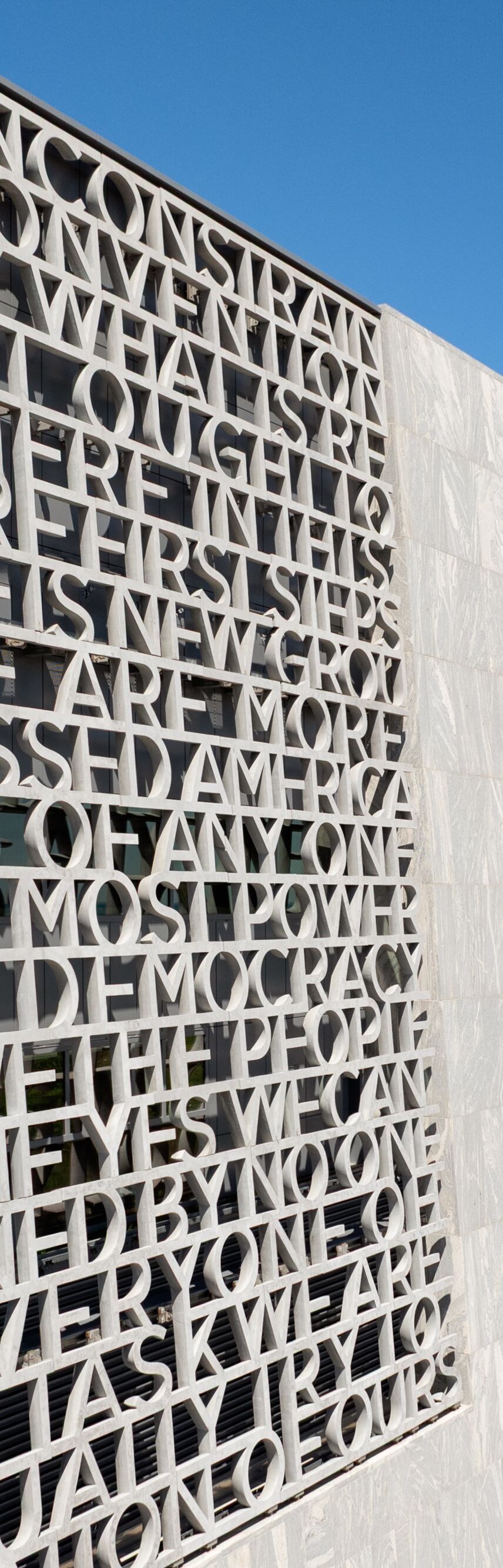 Architectural facade with text and lake view