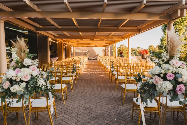 view of wedding aisle with chairs and flowers