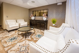 Spa lobby with white armchairs.